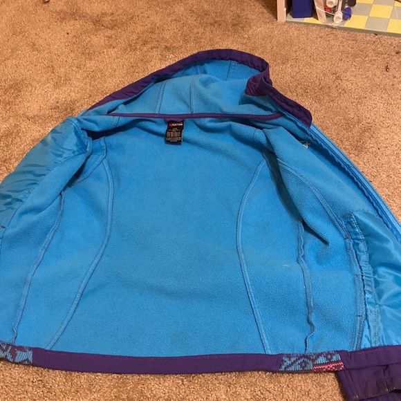Purple light winter jacket. Has a snowflake pattern on the sides. - Picture 3 of 6